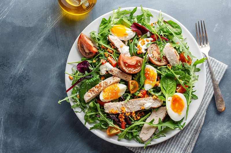 Salad with meat and eggs in a plate