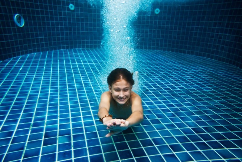 Young kid swimming in pool