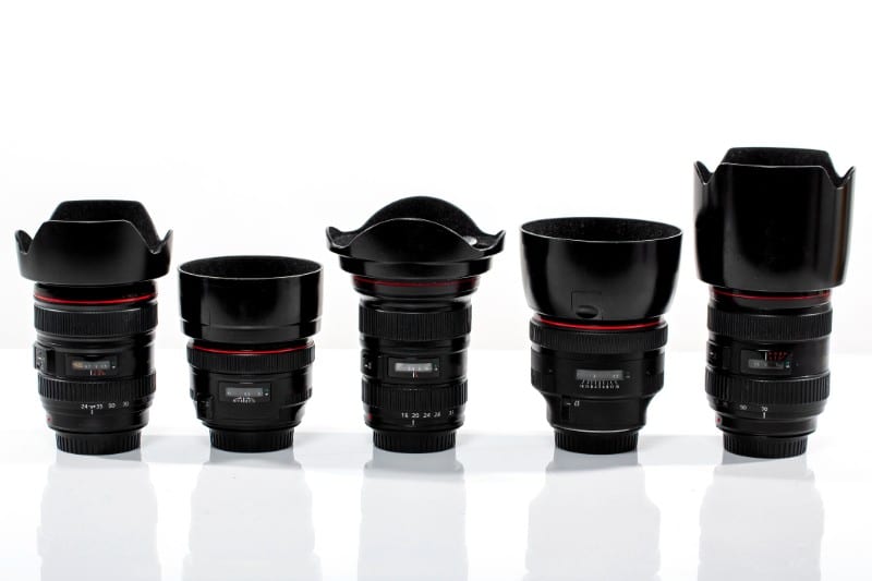 Camera lenses arranged against a white background